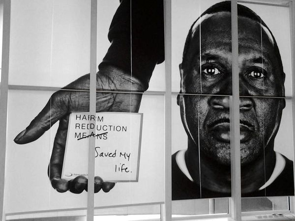 Exhibit 3 at the Harm Reduction Coalition.
                         A Black person is holding a sticky note that says
                         Harm Reduction Saved My Life.